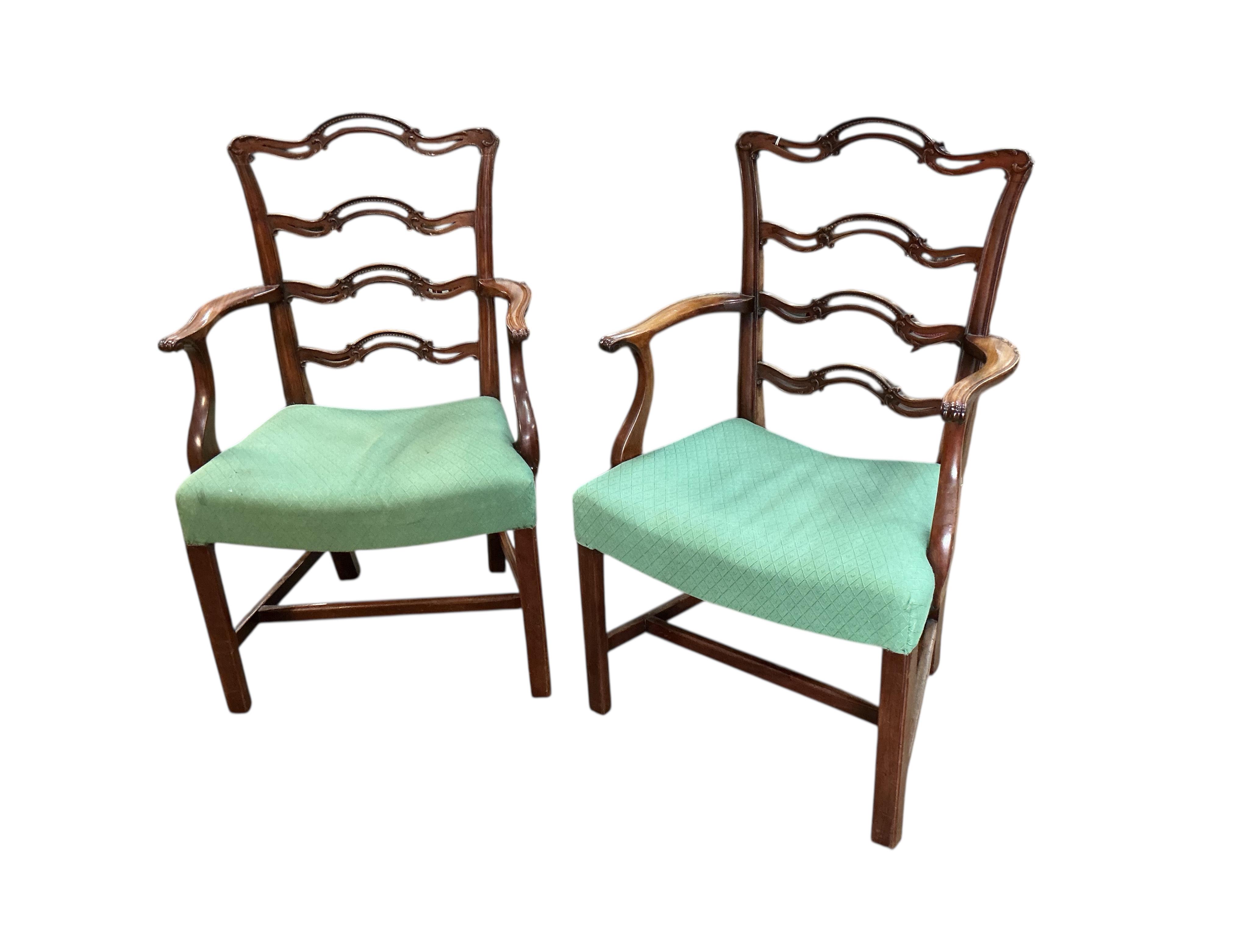 A set of nine George III mahogany pierced ladderback dining chairs, two with arms